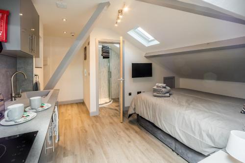 a bedroom with a large bed and a sink at Edgerton Stays in Huddersfield