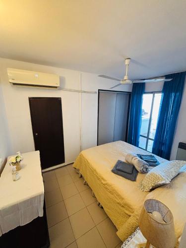 a bedroom with a bed and a table and a window at Departamento La Merced in Córdoba