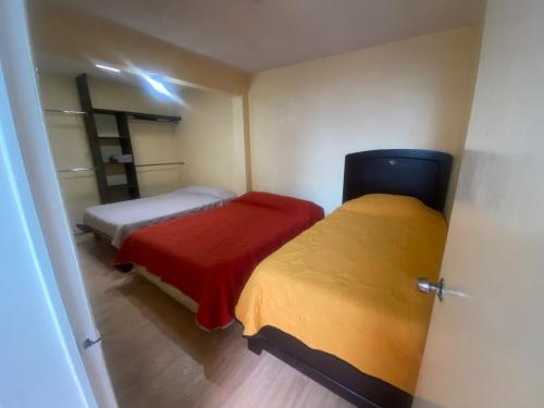 a small bedroom with two beds in a room at La Casita Azul in Orizaba