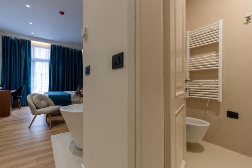 a bathroom with two sinks and two toilets in a room at Golden City Boutique Hotel Tirana in Tirana