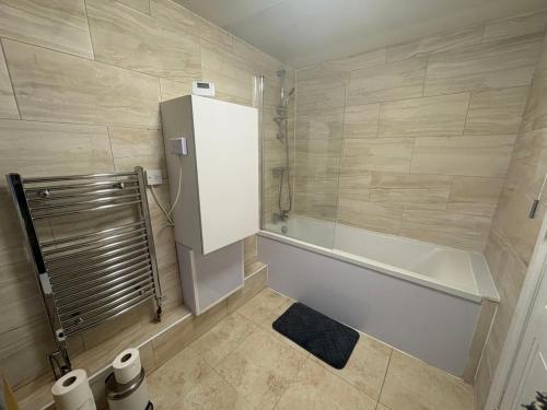 a bathroom with a shower and a bath tub at 2 Bed Flat - Sleeps 3 - Parking - Wifi in West Boldon