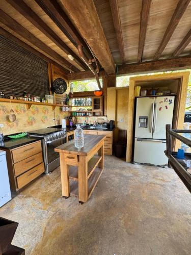 a kitchen with a refrigerator and a table in it at Cabaña Olas del Viento 1 in San Bernardo del Viento