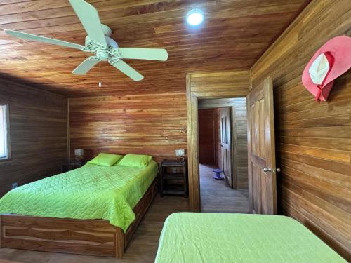 a bedroom with two beds and a ceiling fan at Cabaña Olas del Viento 1 in San Bernardo del Viento