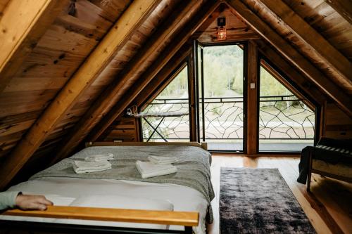 a bed in a room with a large window at Mountain rest Brezna in Plužine