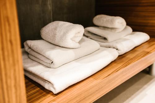 a bunch of towels are stacked on a shelf at Karlo Main Square Apartments in Zagreb