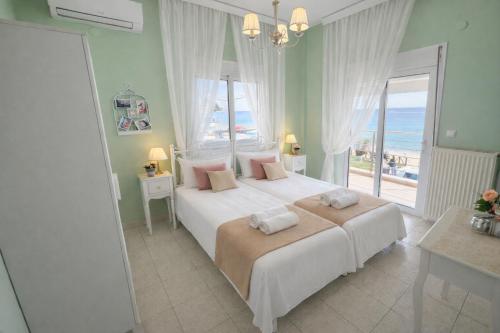 a bedroom with a large bed with a view of the ocean at Vintage Home in Ouranoupoli