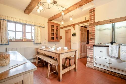 a kitchen with a wooden table in a room at 4 Bed in Shrawley oc-s34861 in Shrawley