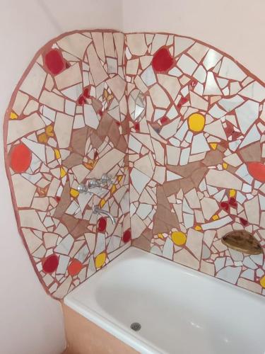 a bathroom with a stained glass window on the tub at Autóctona in Villa Cura Brochero