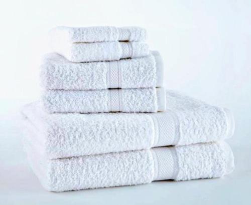 a stack of white towels stacked on top of each other at Deluxe Room! in Lucan