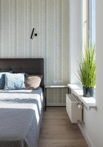 a bedroom with a bed and a table with a plant at Deluxe Room! in Lucan
