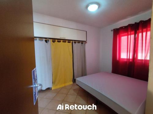 a bedroom with a bed and a yellow and red curtain at Ca Gabbiano 6 in Santa Maria