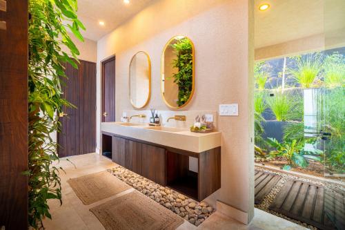 a bathroom with a sink and a large window at Casa Riverstone in Dominical