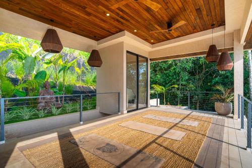 a room with a large glass door and a patio at Casa Riverstone in Dominical