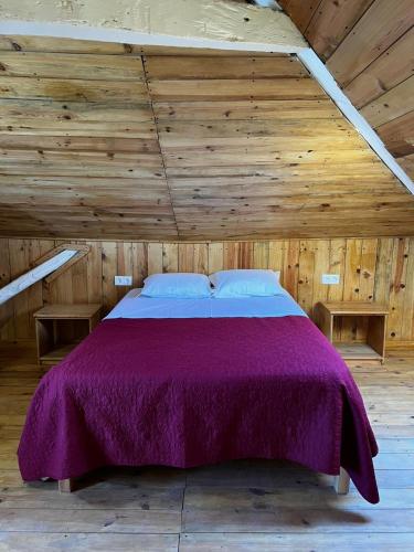 a bedroom with a purple bed in a wooden ceiling at Sailor Setubal in Setúbal