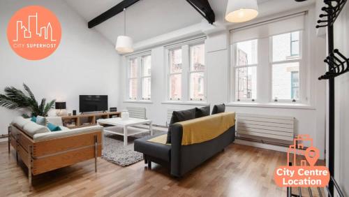 a living room with a couch and a chair at City Superhost - Northern Quarter Loft Conversion in Manchester
