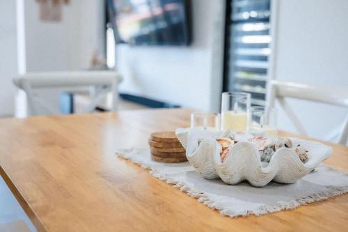 a table with a plate of cookies and glasses on it at The Shell Shack on Whisper Bay in Cannonvale