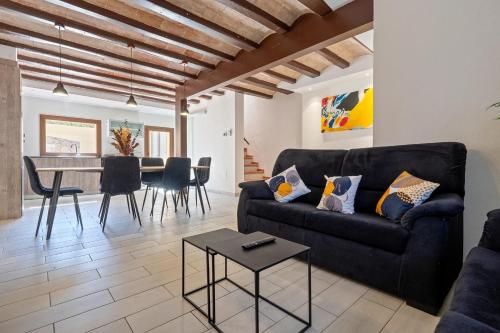 a living room with a couch and a table at Hauzify I La Caseta in Santa Cristina d'Aro