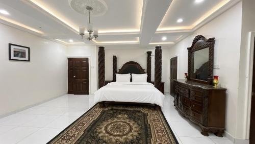 a bedroom with a bed and a mirror and a rug at Duswin Hotel Gloucester, Freetown, SL in Freetown