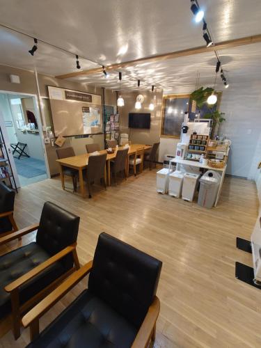 a large room with tables and chairs in a store at 宿 inn TEK-TEK in Sanuki