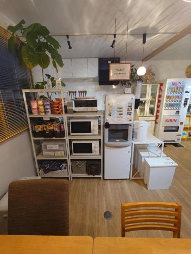 a kitchen with a counter with appliances in it at 宿 inn TEK-TEK in Sanuki
