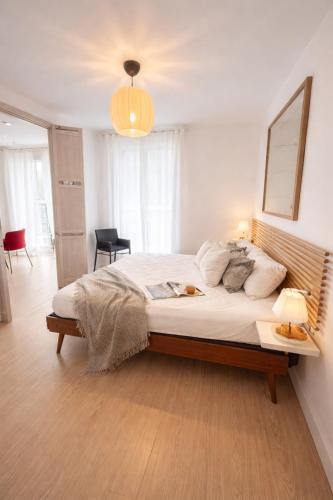 a bedroom with a large bed and a table at 31CaL QuEROL Boutique centre Puigcerdà in Puigcerdà