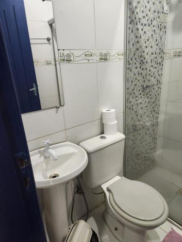 a bathroom with a toilet and a sink and a shower at Yves Hotel in Porto Velho