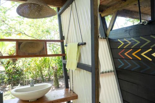 a bathroom with a sink and a window at El Vijo Surf in Nuquí
