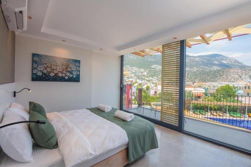 a bedroom with a large bed and a large window at Asfiya Loft Apartments in Kalkan