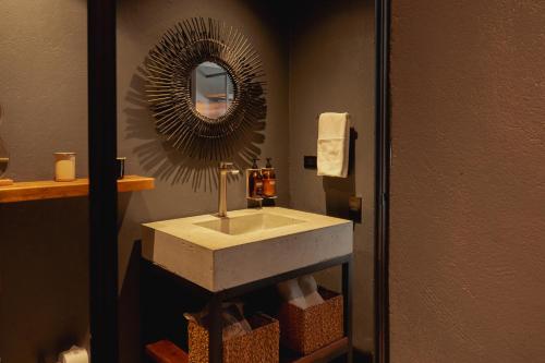 a bathroom with a sink and a mirror at Sui Boutique Hotel in Medellín