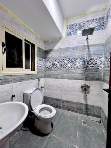 a bathroom with a toilet and a sink at Saray Hotel Dahab in Dahab