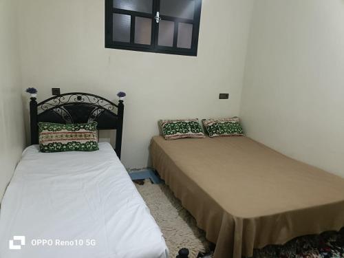 two beds sitting next to each other in a room at Gite souran in Imlil