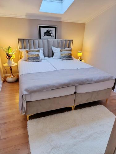 a bedroom with a large bed with white sheets and pillows at Elite Apartment Jasmina in Bihać