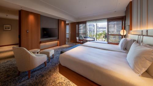 a hotel room with a large bed and a television at InterContinental Yokohama Pier 8 by IHG in Yokohama