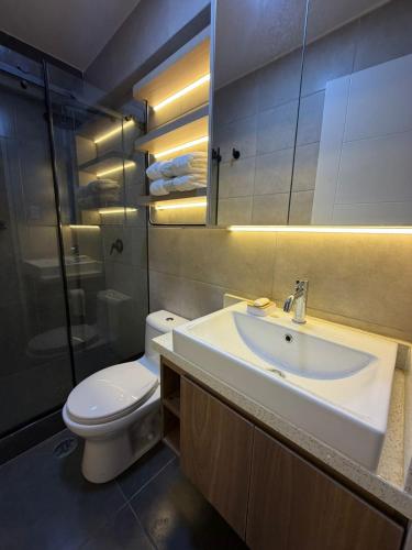 a bathroom with a white sink and a toilet at Miraflores Alcanfores in Lima