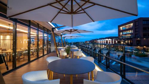 a balcony with tables and chairs on a building at InterContinental Yokohama Pier 8 by IHG in Yokohama