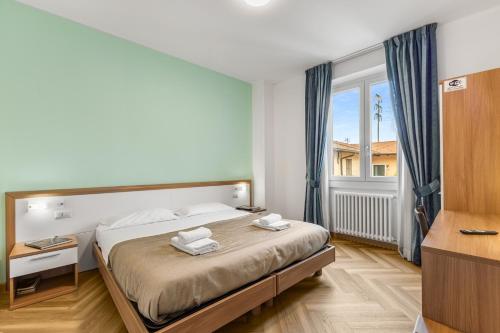 a bedroom with a bed and a large window at Casa Diego, Colico Centro Living in Colico