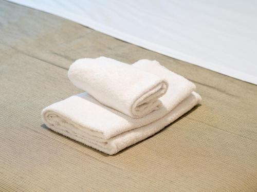 two white towels are stacked on a table at Casa Diego, Colico Centro Living in Colico
