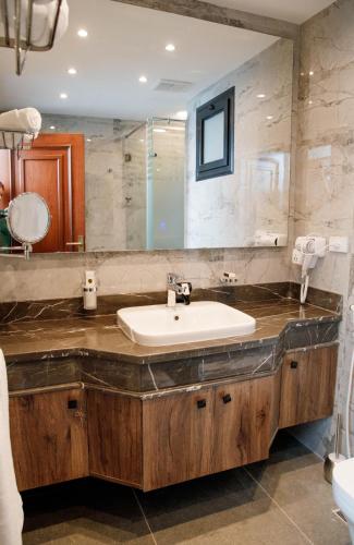 a bathroom with a sink and a mirror at Nile Trans Hotel in Cairo