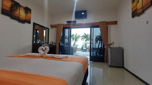 a bedroom with a bed with a towel on it at Melaya Beach Resort Queen Bed in Penginuman