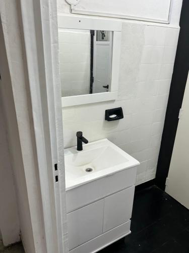 a bathroom with a white sink and a mirror at Viví el mundo Boca en el HOSTEL DEL 10 in Buenos Aires