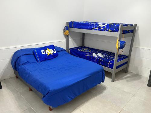 a bedroom with two beds and a bunk bed at Viví el mundo Boca en el HOSTEL DEL 10 in Buenos Aires