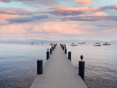 a wooden pier in the water with boats on it at 1st Cabin in Homewood