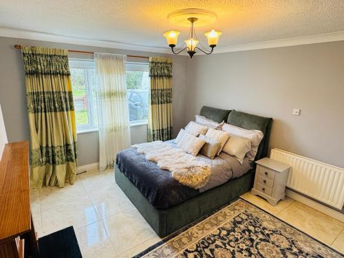 a bedroom with a bed and a chandelier at Lord Windsor's Regal Chamber in Drogheda