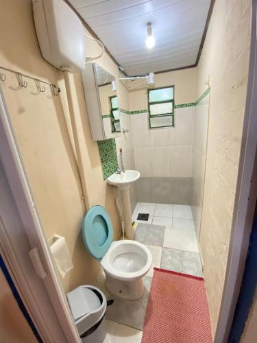 a small bathroom with a toilet and a sink at Pousada e Hostel Cantinho dos Chalés in São Luiz do Paraitinga