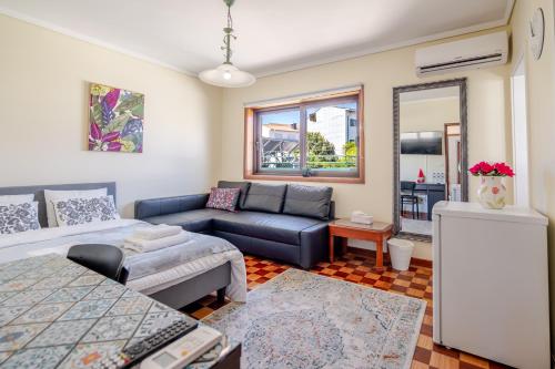 a living room with a couch at Maia Oporto Suites in Maia