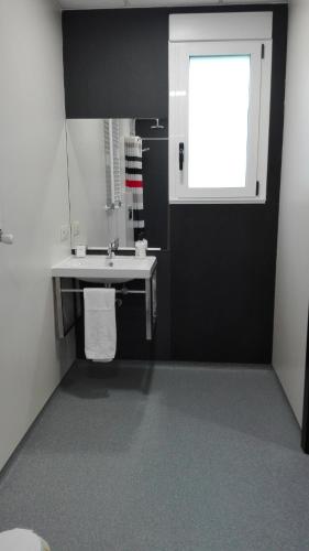a bathroom with a sink and a window at Hostel Boente in Boente