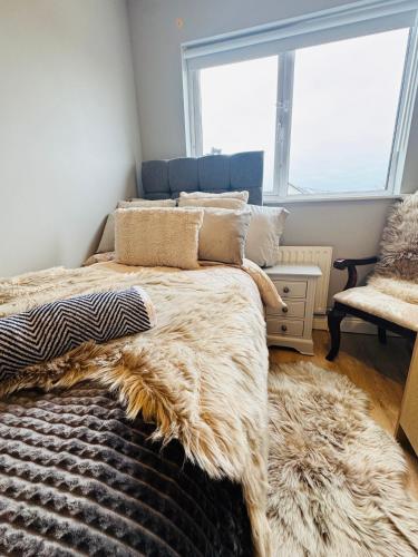 a bedroom with a large bed with a large window at The Emerald Prince Alcove in Drogheda