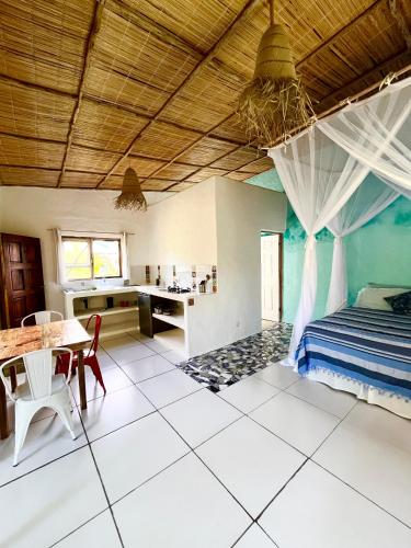 a bedroom with a bed and a table and a desk at Jambalau House in Lopes