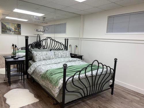 a bedroom with a black bed in a room at Charming Central Abbotsford Retreat, Cozy Suite in Abbotsford
