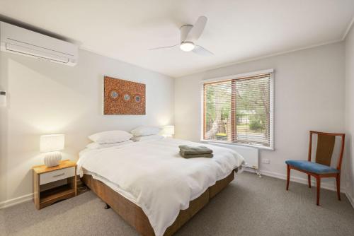 a bedroom with a large bed and a window at Beach House Silverleaves in Cowes